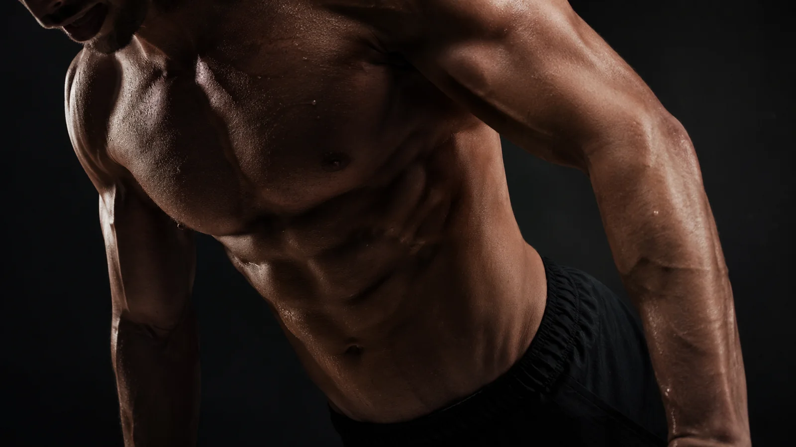 Muscular male torso in dramatic lighting